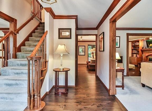 A wonderful entry hall with beautiful woodwork, new wood floors and an open floor plan invite you in