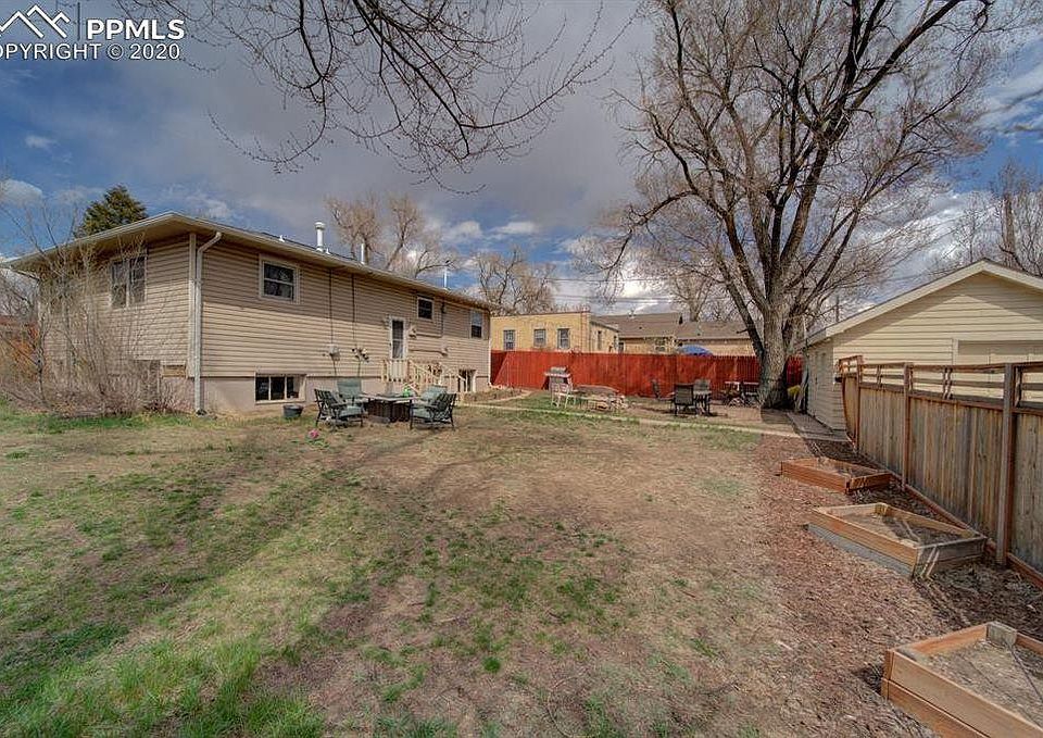 fenced back yard, entrance to unit B. Garage on the right side of the photo is available with the unit for a fee.