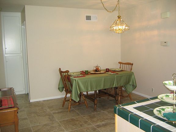 The dining area is open to the kitchen & has new tile floors.