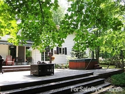 River side of home : tiered deck, hot tub, sunsetter awning upper left attached to house