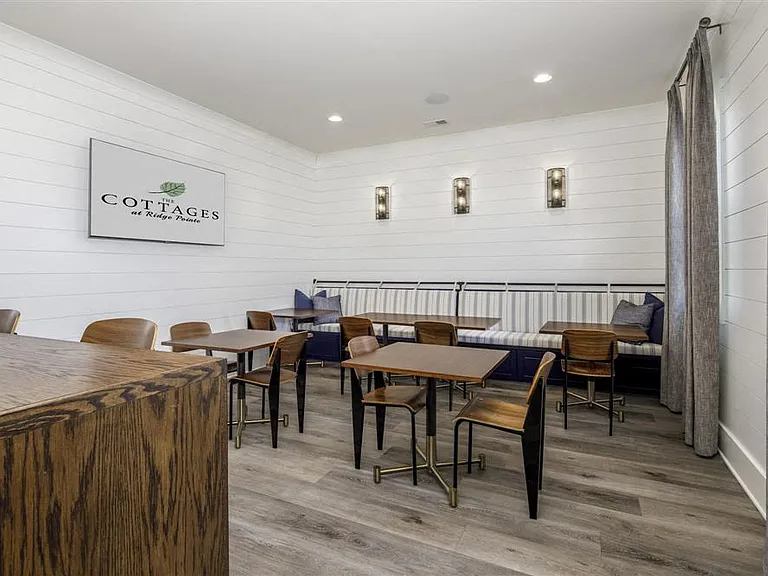 Clubhouse interior with leasing desk and relaxing sitting area.