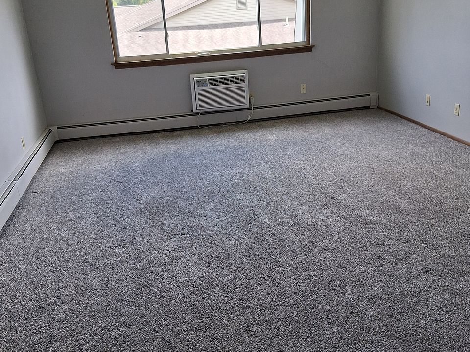 Large living room with sleeve air conditioner.
