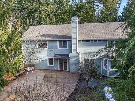 Private, fenced yard with large deck, and fruit trees.