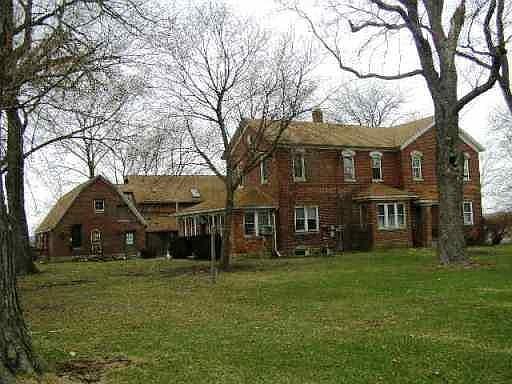 house and carriage house with office building in back