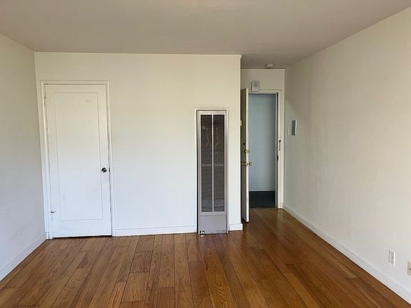 Hardwood floors - door at left is a walk-in closet with shelves