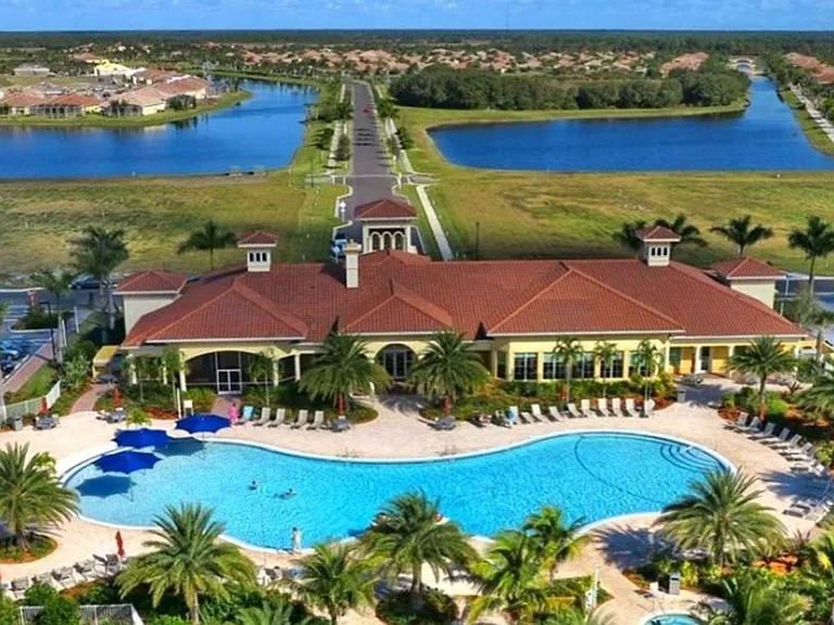Aerial view of clubhouse, pool, and lakes.