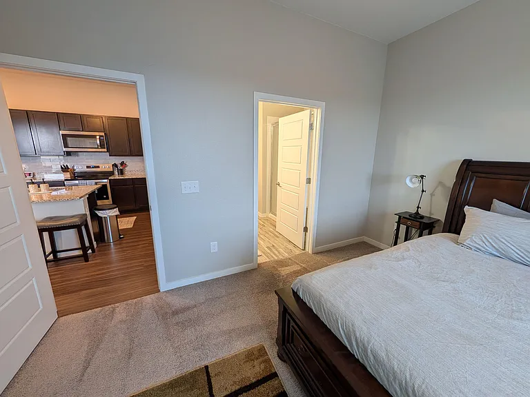 Coffee table next to bed and common area