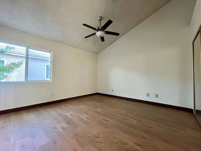 Master Bedroom, another angle view from the door, newly-installed wood laminate flooring and new mini-blinds