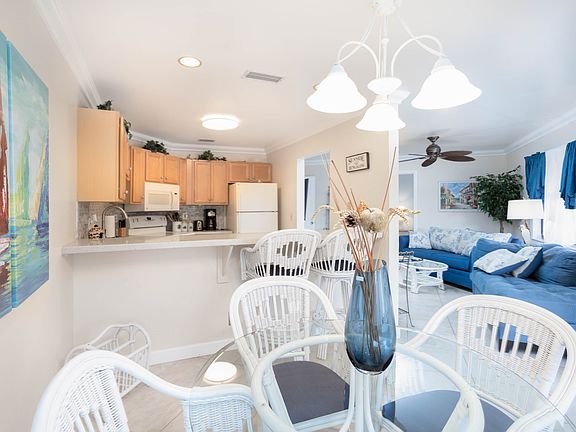 Dining room area with counter bar and bar stools on left and living room area on the right.