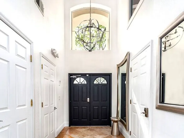Welcome to the enchanting entry foyer of our DisneyEstate! Step inside and witness the stunning views of your private pool, championship golf course, and resort clubhouse with amenities like Lap Pool, Pickleball, Tennis, and Children's Playgrround.