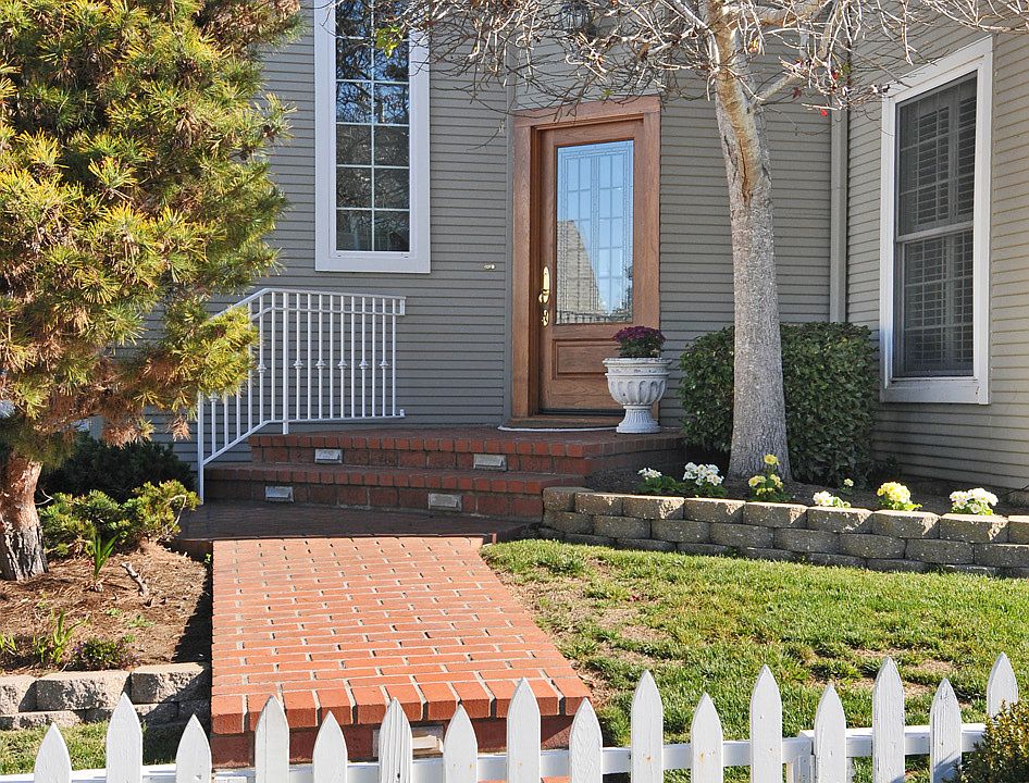 Brick walkway leads to leaded glass Front Door
