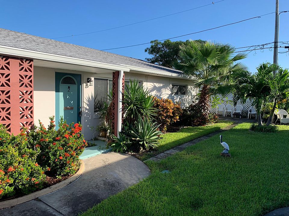 Private front entry with lush surroundings.