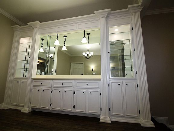 Dining room with built-in countertop, china hutches, storage, and dimmable LED lighting