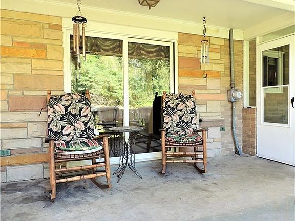 Relax and enjoy breakfast or a after-dinner coffee on the side porch that overlooks the beautiful yard.