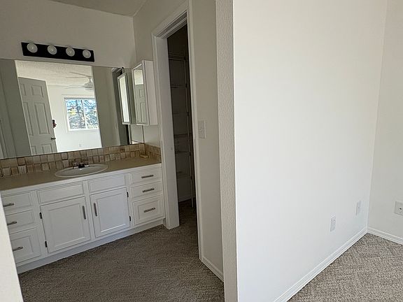Sink area in primary bedroom. This shows where the walk-in closet is.