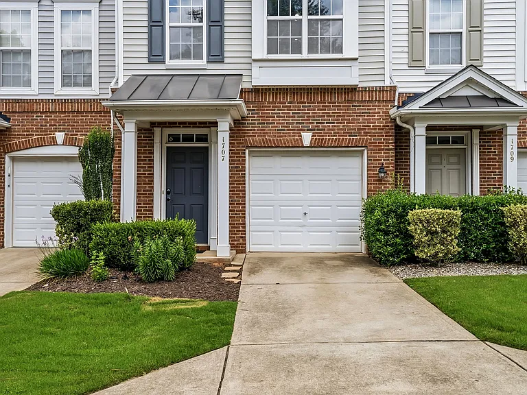 Front door and garage and parking in driveway