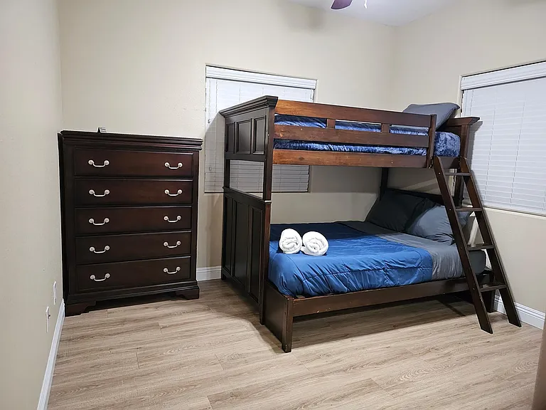 Bedroom 3 - bunk bed (1 full/1 twin mattress), dresser, ceiling fan, and closet.