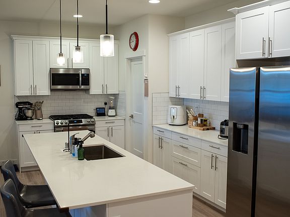 Kitchen. Note the quartz countertops and Stainless steel appliances.
Lot of counter pace and numerous cabinets. Lots of storage.