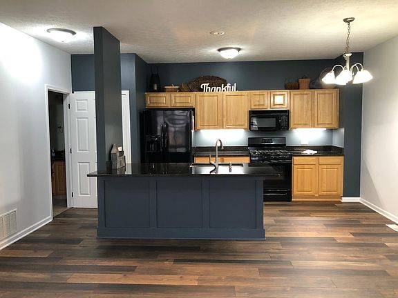Kitchen with 5-burner gas stove and appliances