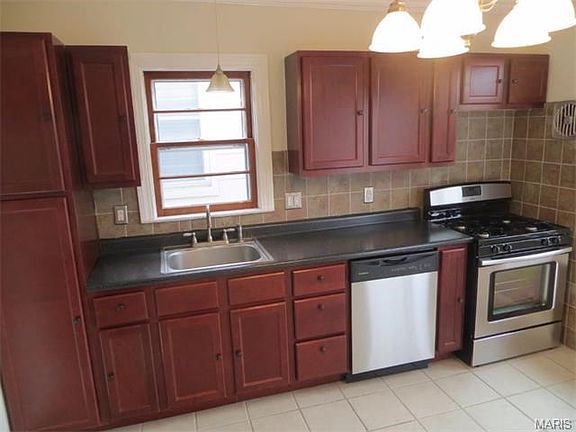 Kitchen with new dishwasher, stove and lighting.