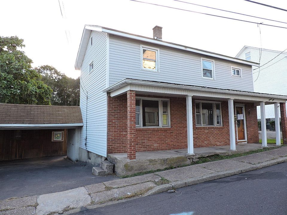 Front of house with covered parking