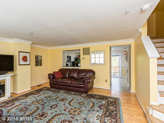 Spacious wood-floored living room provides