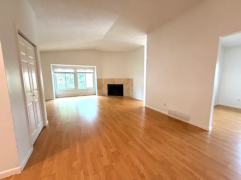 From the front door entrance toward the large living room- jacket closet on the left
