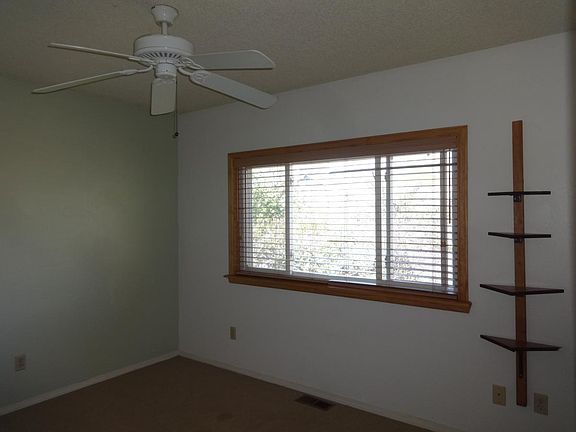 Second bedroom, upstairs with oversize window and plantation