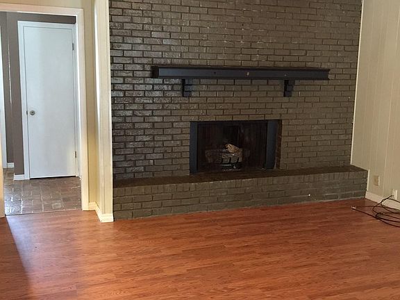 Living room with soaring ceiling and fireplace