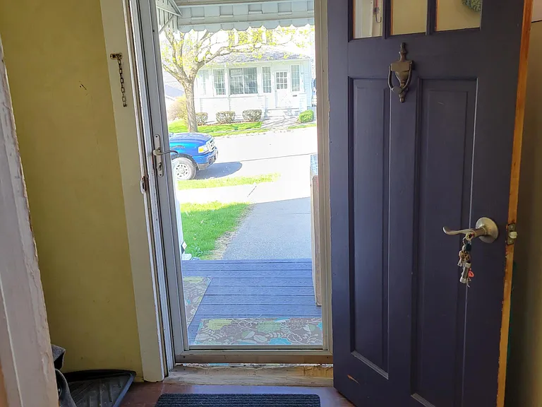Looking out your private front door across front porch to neighbor hood and quiet street.