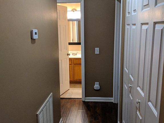 Hallway to bedrooms with laundry closet.