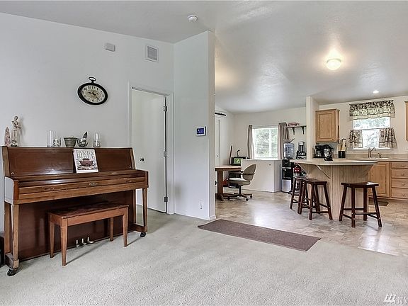 View from entry into kitchen, master on left. Split bedroom design - master on one side, other bedrooms on the other. 