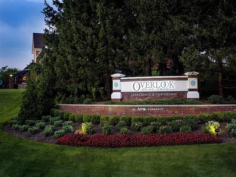 Community entrance sign at dusk