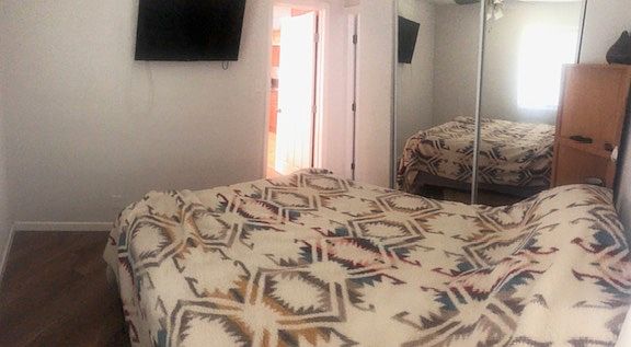 Queen size Bed with full size TV and Roku.