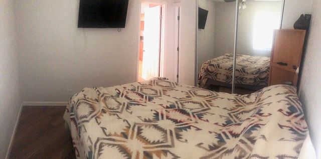 Queen size Bed with full size TV and Roku.
