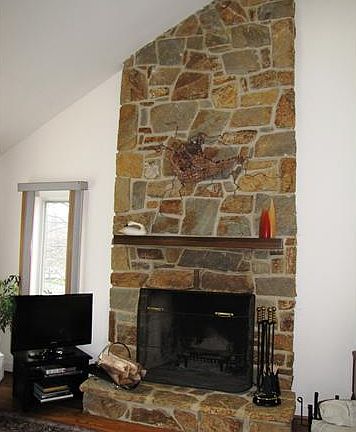 Floor-to-Ceiling Stone Fireplace in Living Room