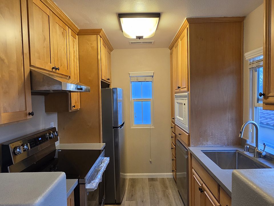 refreshed full kitchen with brand new appliances (refrigerator, electric range, range hood, dishwasher), microwave, new kitchen sink, plenty of storage