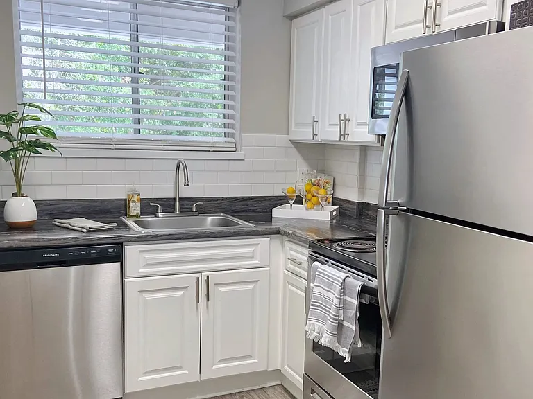 Be inspired by the culinary brilliance of our kitchens, adorned with a radiant subway tile backsplash, gleaming stainless-steel appliances, and ample white cabinetry for maximized storage.