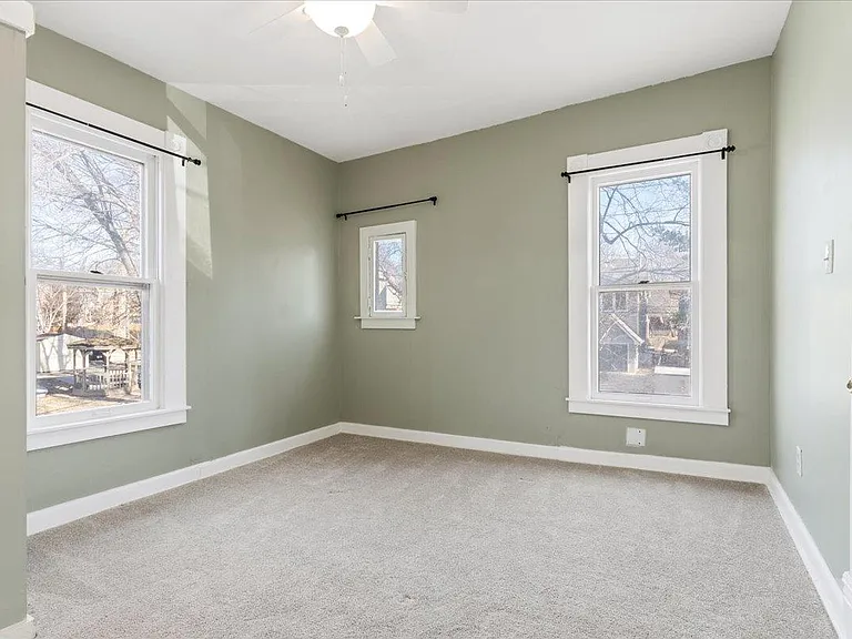 Primary bedroom at back of unit. Fresh paint and newer carpet and light fixture.