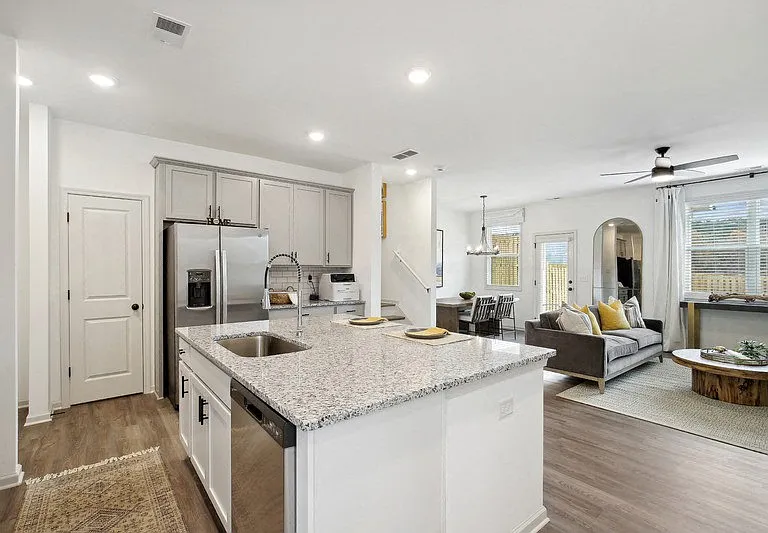 Elegant, open-concept kitchen with stainless steel appliances, generous storage, and a seamless flow into the living area.