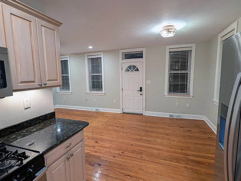 The original Hartland pine flooring is throughout the house. Looking from the kitchen into open living space in the front of the house.