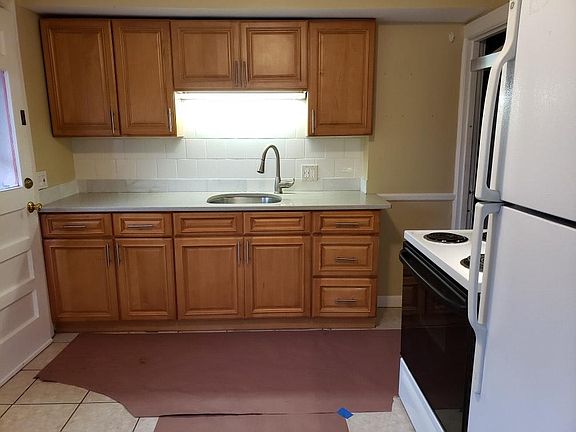 Brand New Kitchen with stone quartz countertop, modern faucet, tile floor, exhaust hood over electric stove/oven, clean, full size refrigerator. Private washer and dryer machines in your private half basement.