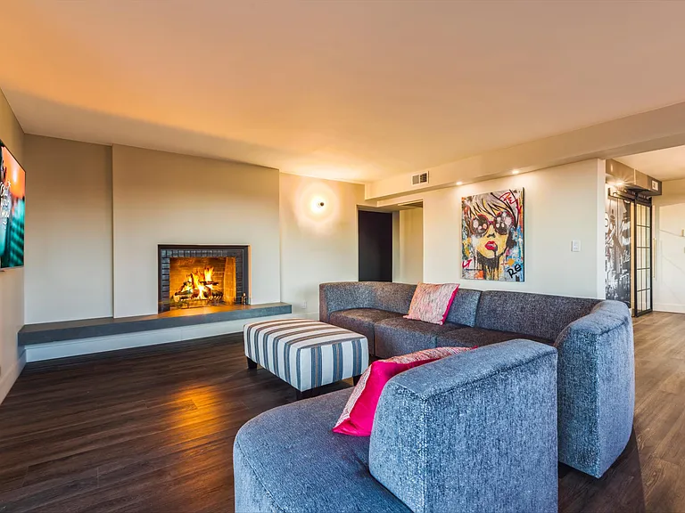 Living Room with 65" Smart TV & Wood burning Fireplace