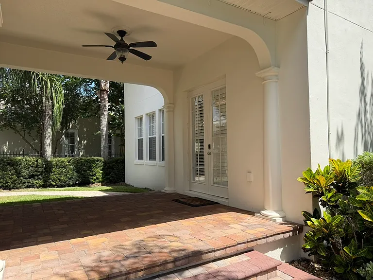 Back covered porch with grassy area and fence