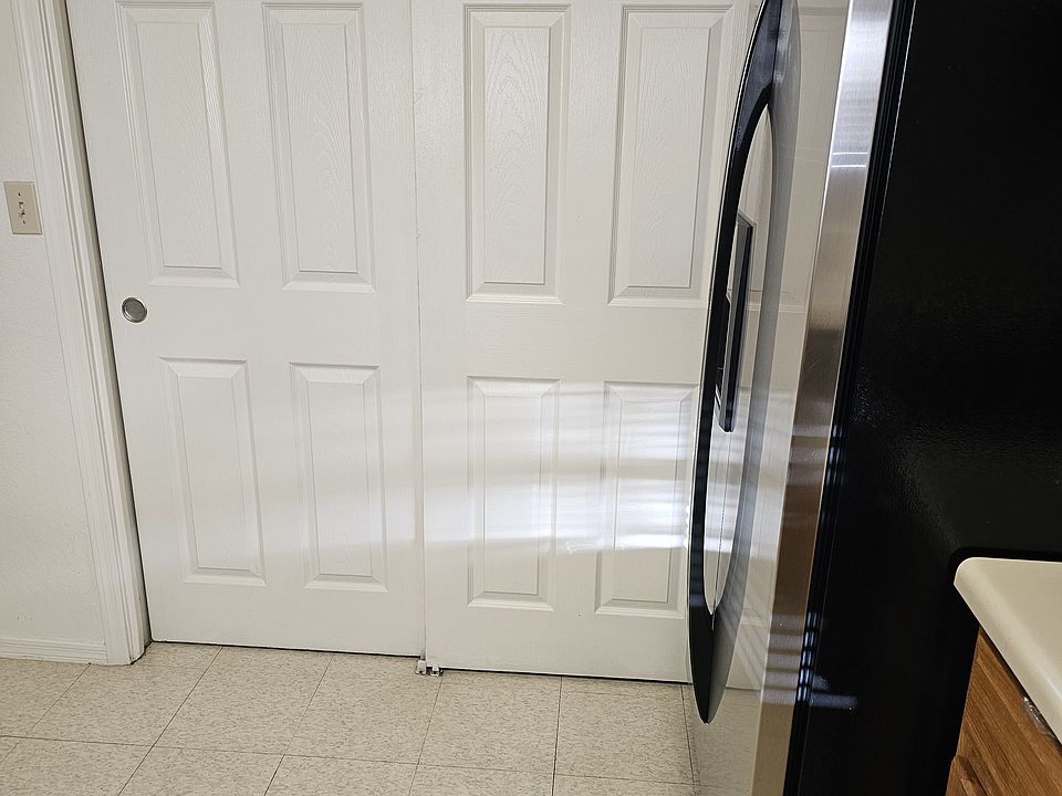 View of laundry area with sliding doors