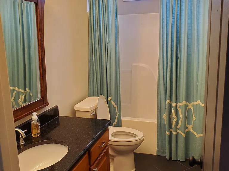 Downstairs bedroom with attached full bathroom.