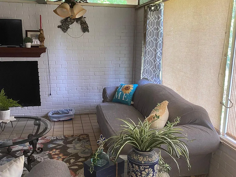 Living room overlooking private backyard with privacy fence.