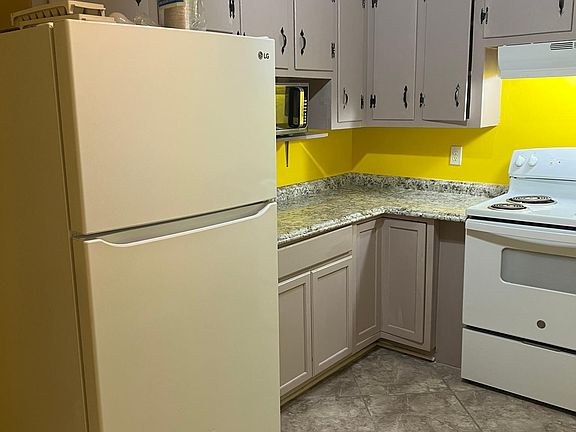 Kitchen brand new refrigerator tile flooring