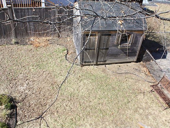 The backyard also has a bike shed and several gardens.