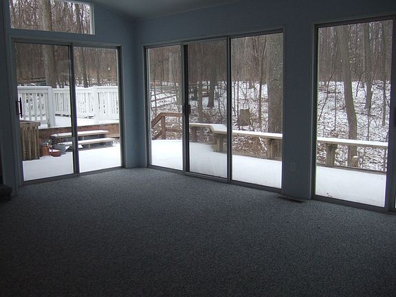 Three season room opens up to two level deck